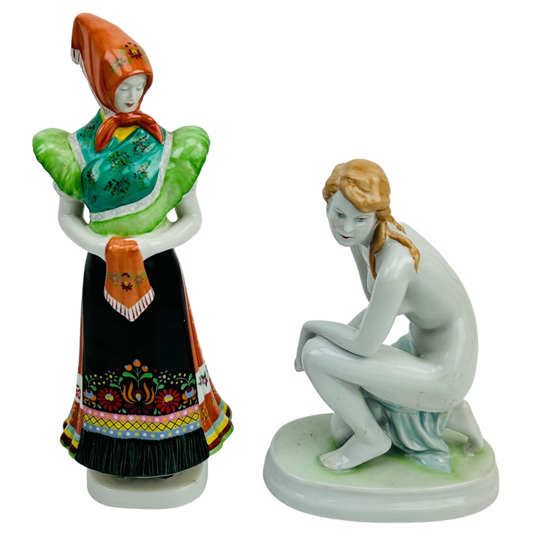Zsolnay Pecs Nude & Hollohaza Farmer Girl Figurine: Estate lot of 2 Hungarian hand painted porcelain curio cabinet display figurines. Includes 1 x Zsolnay Pecs Art Deco seated nude lady with flowing blonde hair, mounted atop an oval stepped base. 1 x H