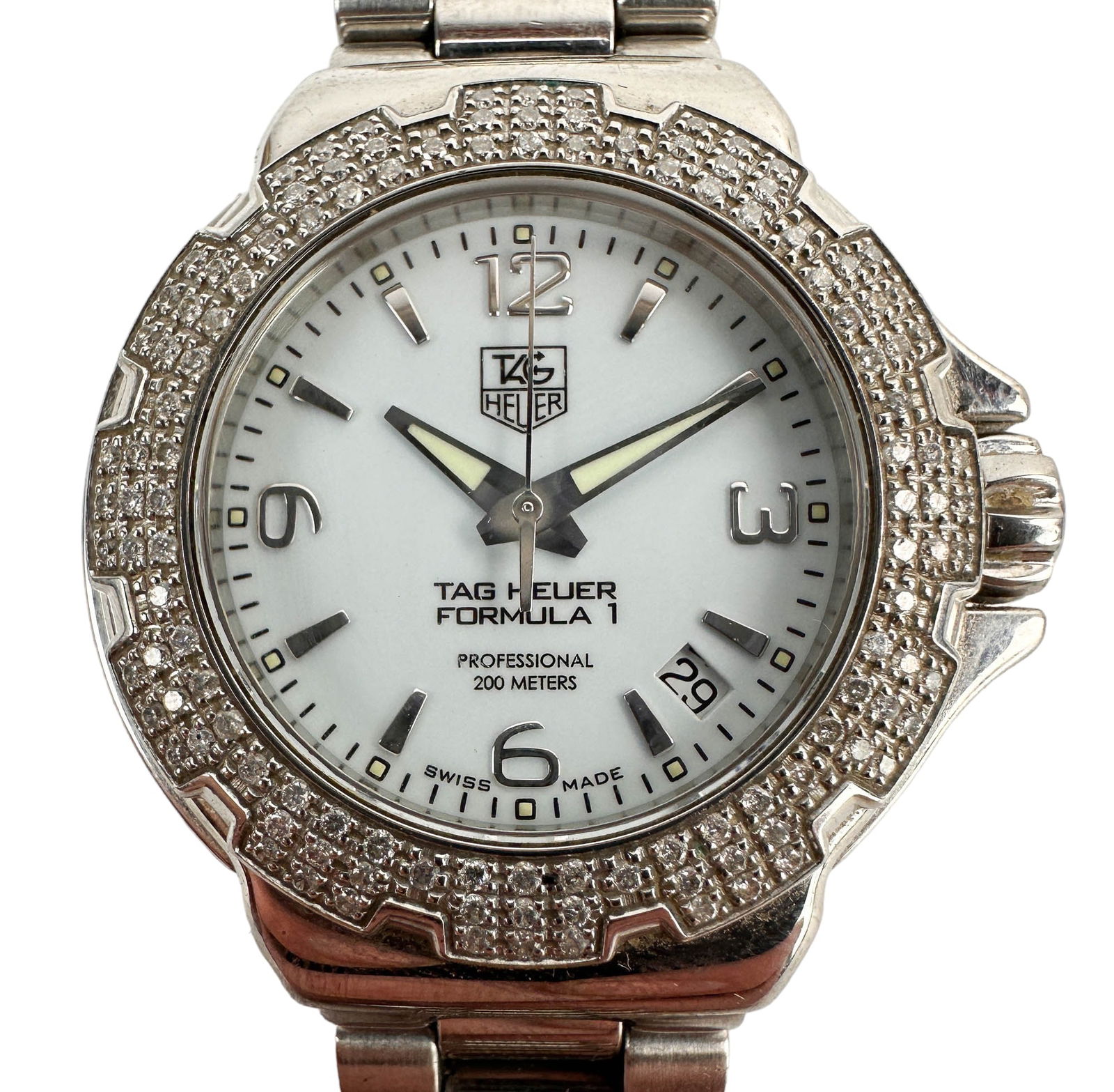 Tag Heuer Formula 1 Diamond Bezel Lady Wrist Watch: Ladies Tag Heuer Wrist Watch. Model number WAC1215. Model name Formula 1. Features a white dial face with bold markers and date function. Quartz battery movement. Stainless steel case and bracelet. Ca