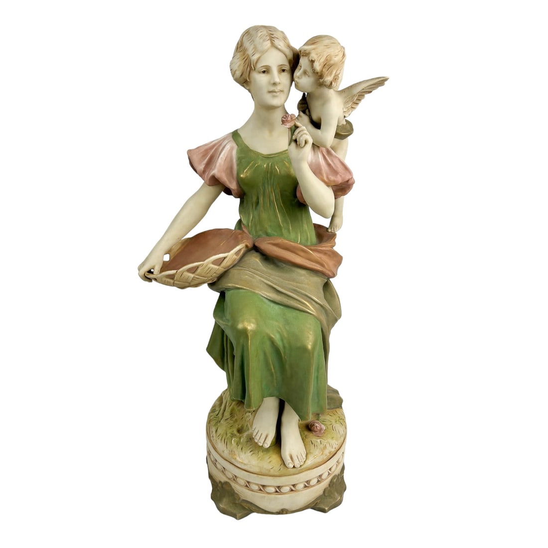 Royal Dux Bohemia Maiden Winged Angel Figurine 23": Early 20th century Art Nouveau LARGE porcelain figurine. Depicts a slender maiden in seated pose, a basket on her lap, holding a flower, the mythological heavenly nude cherub putti perched by her shou