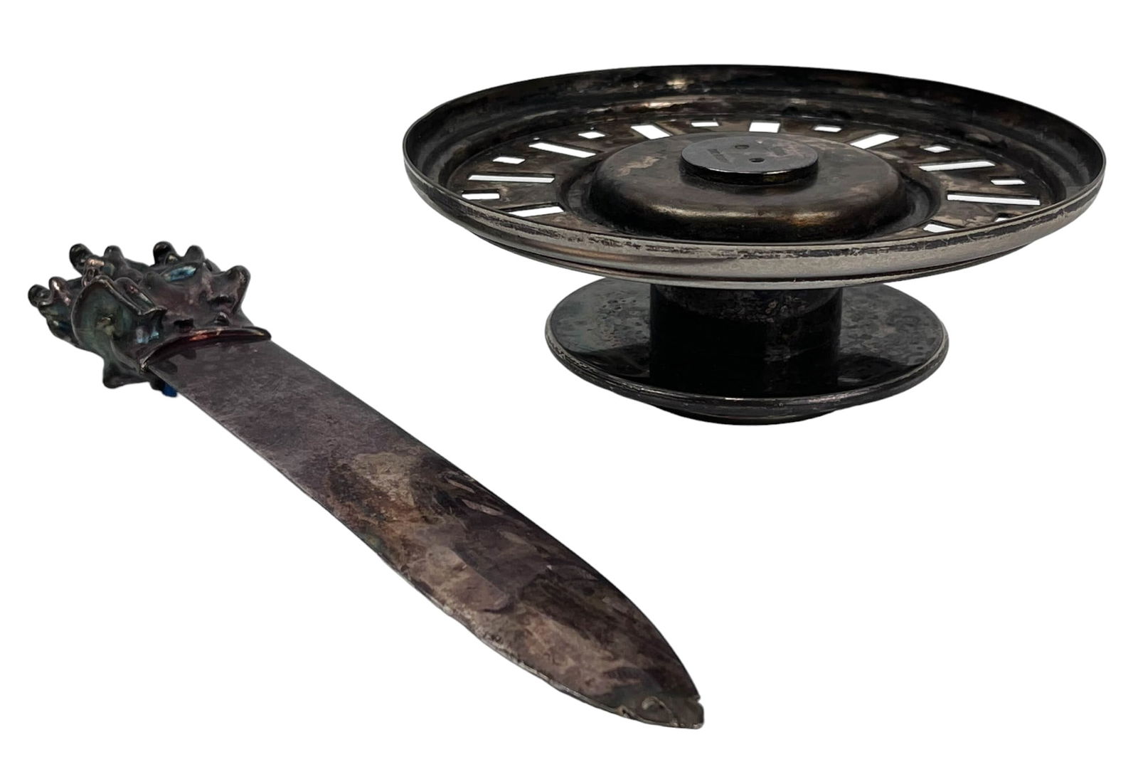 Christofle Letter Opener Swid Powell Candleholder: Estate collection lot of a total of two (2) silver plate articles. Includes ~ One (1) Christofle France letter opener by Jean Filhos ( French, 1921 - 2002 ). Titled Cariatides. Features an erotic scen