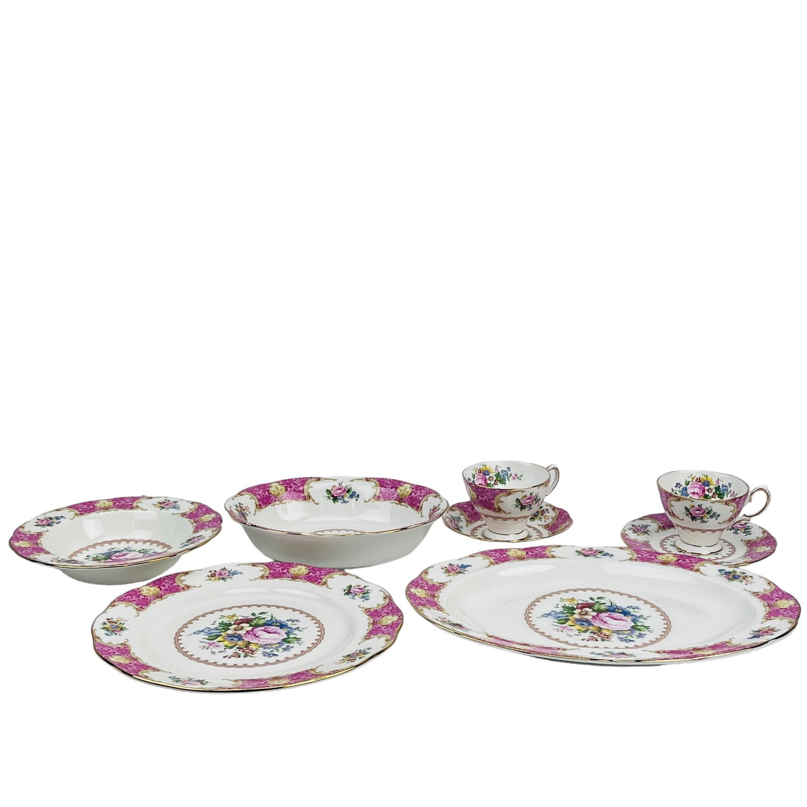 Royal Albert Lady Carlyle Plate Teacup Saucer 24pc: Manufacturer : Royal Albert. Country of origin : England. Pattern : Lady Carlyle. Production years : 1980 - 2022. Features a floral motif against a white and pink ground with a gold trim lined border.