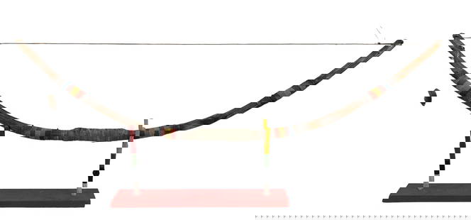 Native American Indian Archery Bow w Display Stand: One of a Kind (OOAK ) handcrafted carved wood, rawhide and beaded bow. Designed to rest on a multicolored Handmade wood stand with a red orange color rectangular wooden base. Measures 42" in length x