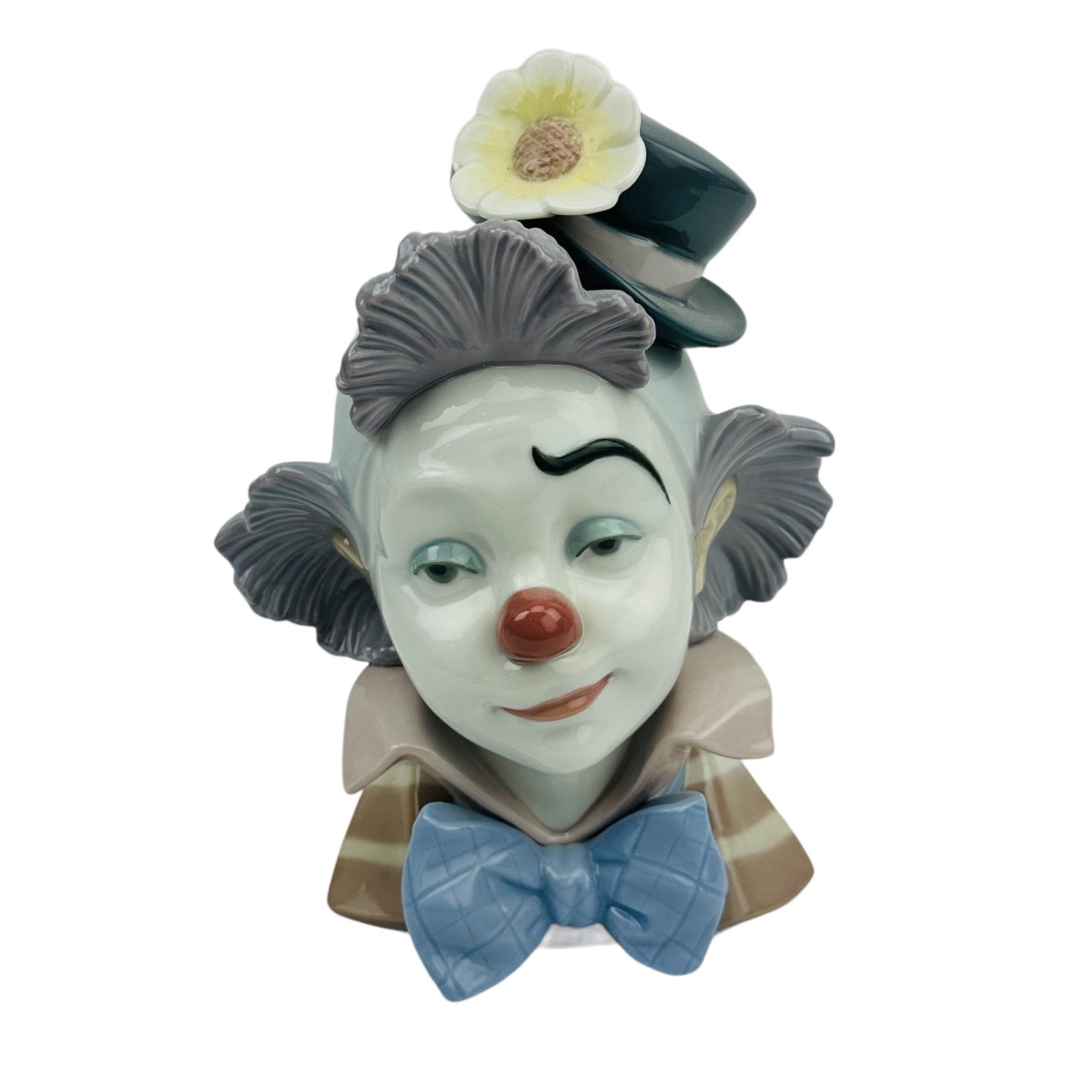 Lladro Star Struck #5610 Porcelain Clown Face Bust: Name / Title : Star Struck. Model number : 5610. Sculptor : Jose Puche. Production Years : 1989 - 1997. Finish : Glazed. Features the portrait of a carnival jester with a yellow flower in his gray cap