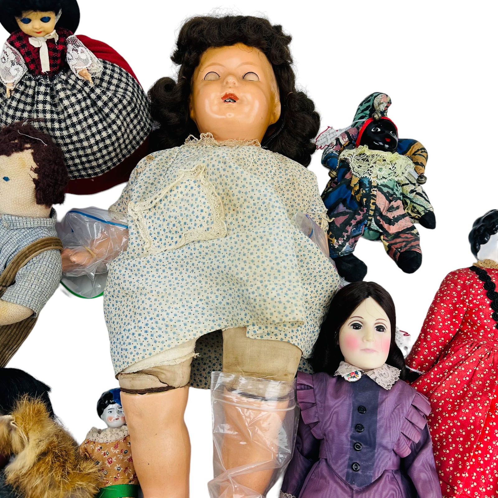 xArmand Marseille Efanbee Ceramic & Cloth Doll LOT: A collection of eight (8) vintage to antique dolls. The lot includes (1) Armand Marseille composition baby doll with dark hair and sleepy eyes,(1) Effanbee plastic doll of Susan B. Anthony, (2) Victor