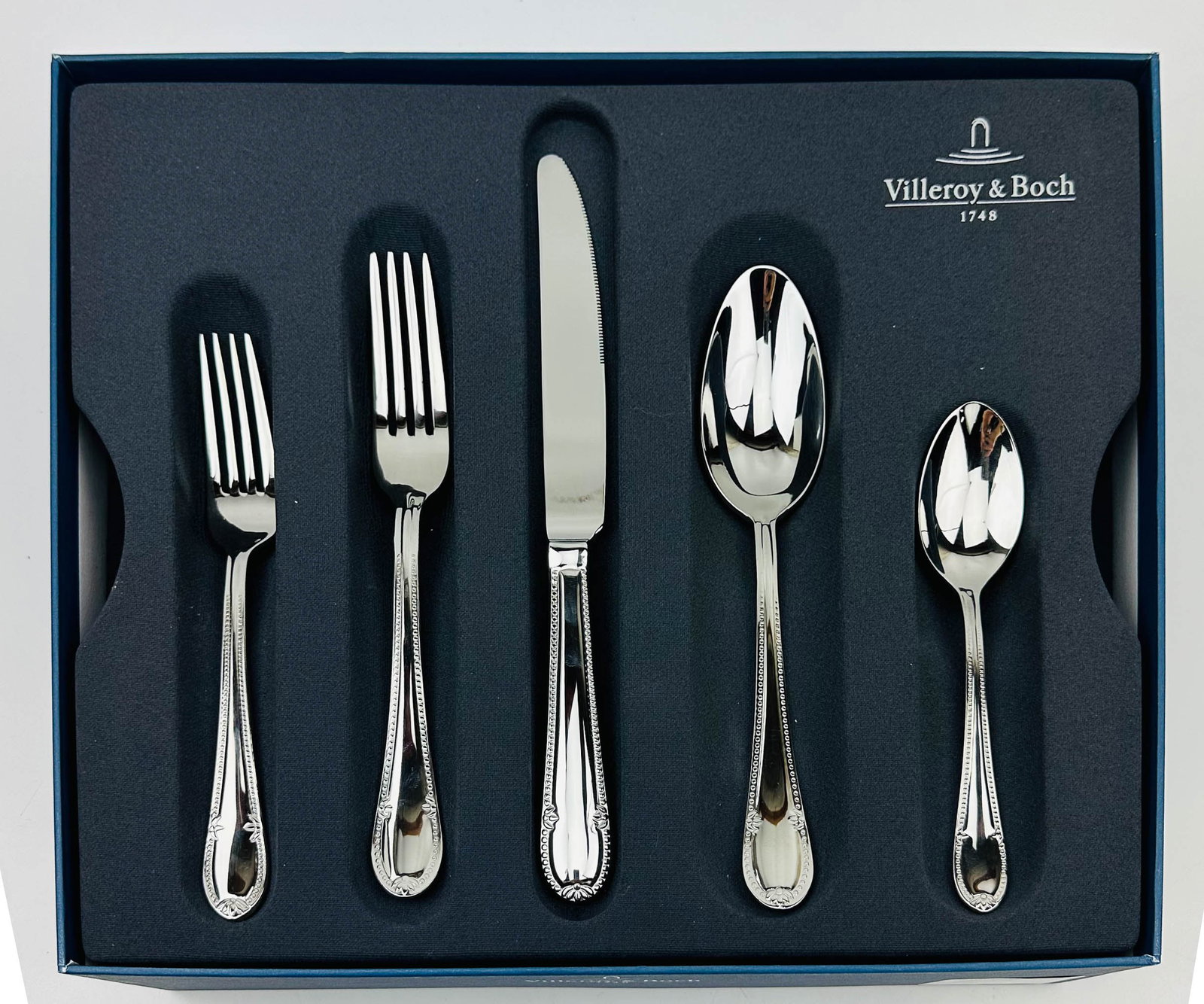 Villeroy Boch Stainless Mademoiselle Flatware 64pc: Manufacturer : Villeroy & Boch. Pattern : Mademoiselle. Circa : 2007. Finish : Glossy. Design features a beaded outline to the handle. Total of sixty four (64). Twelve (12) Teaspoons (6 1/4"). Twelve 