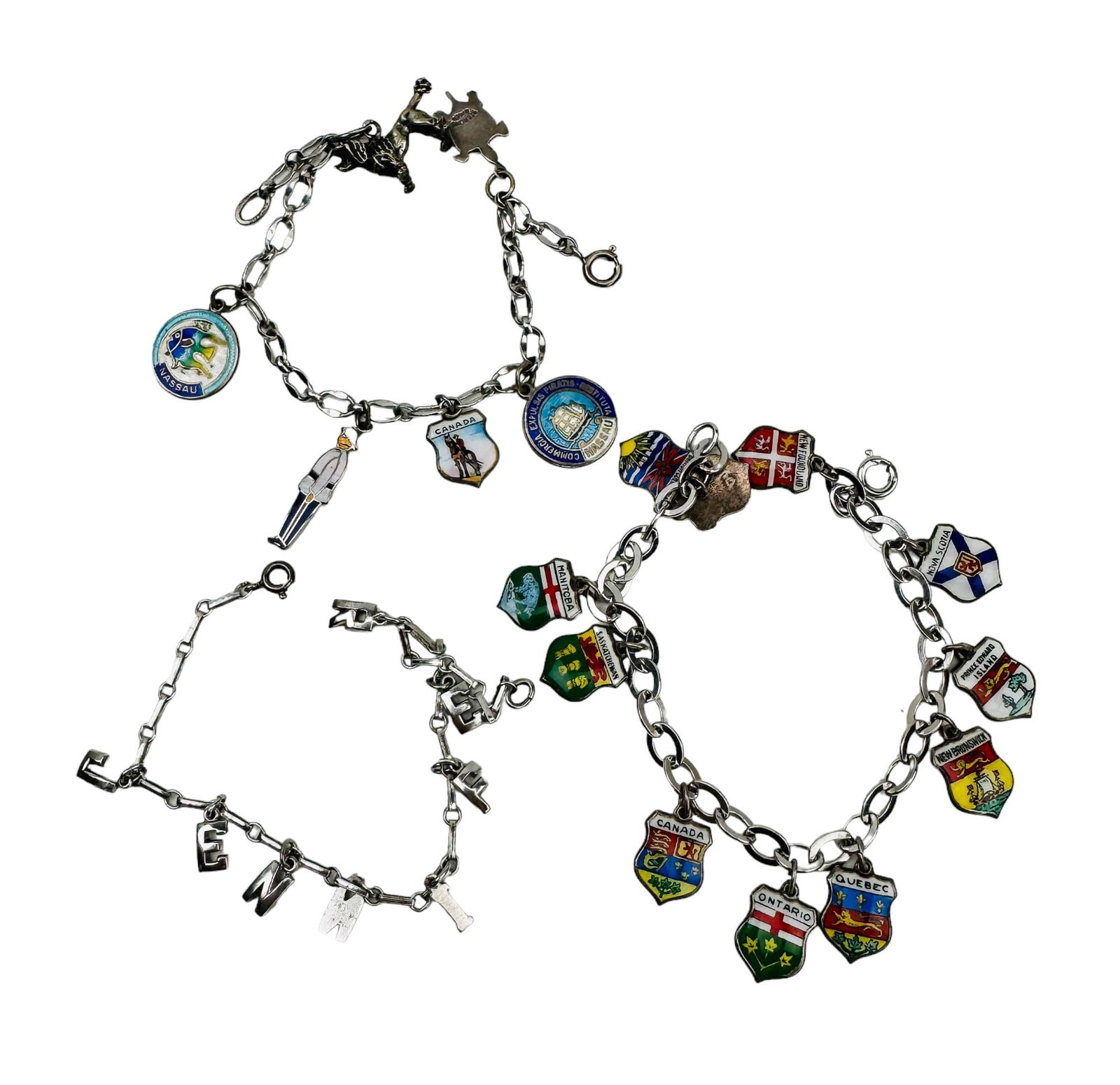 Estate Lot 3 Sterling Silver Charm Bracelets 36g: Estate lot of three (3) sterling silver charm bracelets. One (1) bracelet is Canadian travel charms, all are enameled and all are sterling. 7" x .25" x .10". Eleven (11) charms. One (1) mixed travel a