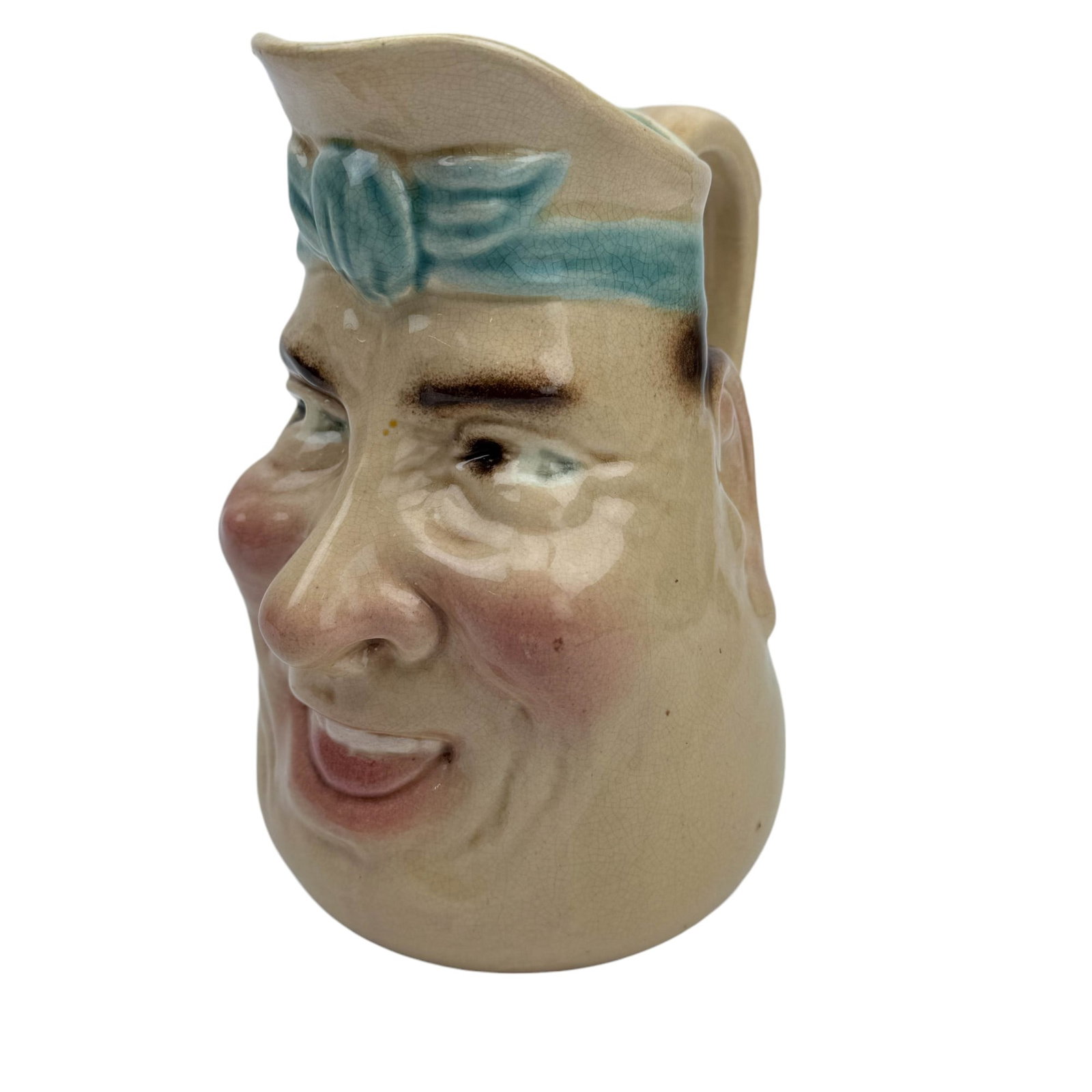 Sarreguemines French Majolica Character Face Jug: Early to mid 20th century European origin earthenware Toby style face pitcher creamer jug. Features the portrait face of a rosy cheek jovial looking man with partial front teeth expose. Glazed finish.