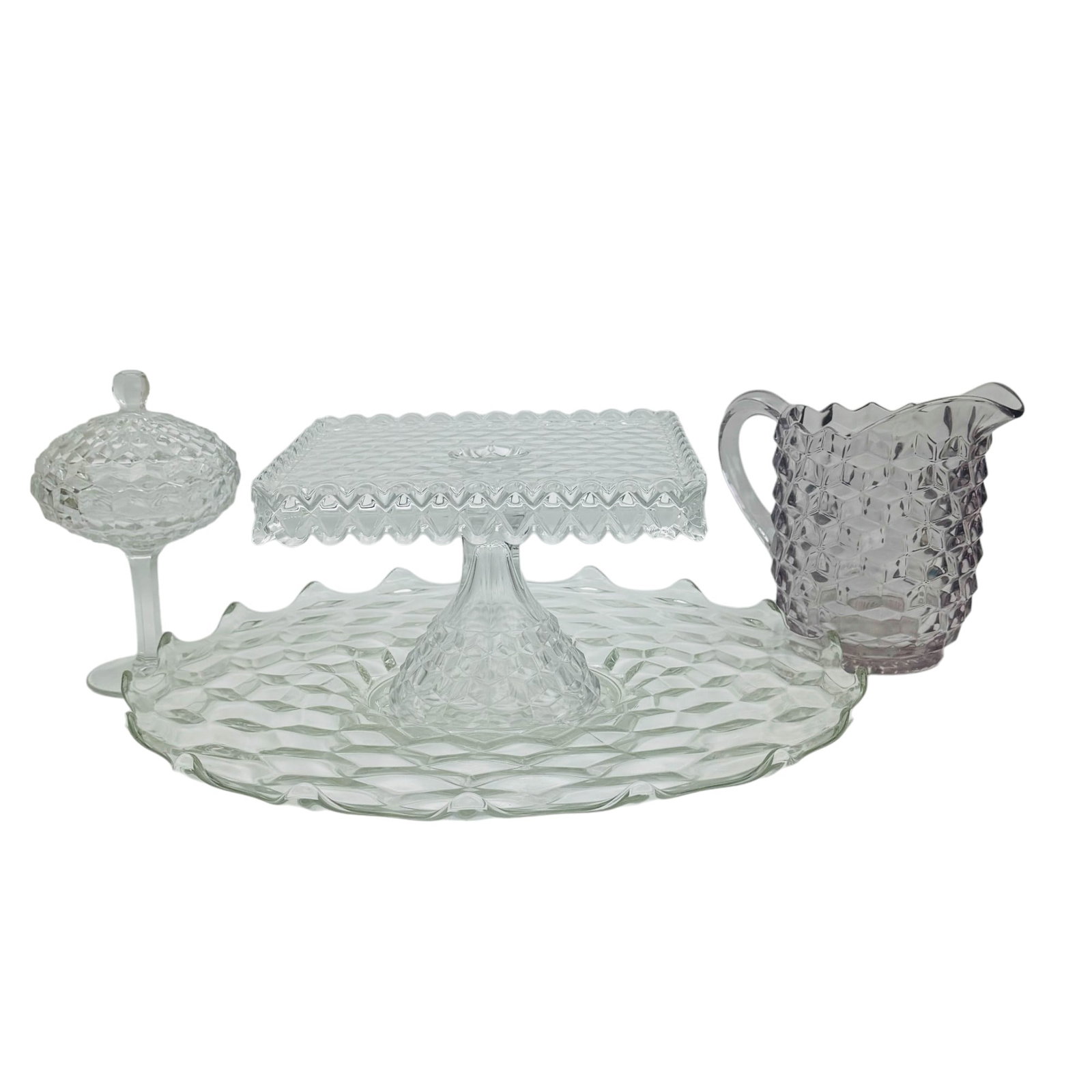 Fostoria American Clear Cake Plate Platter Jug 4pc: Manufacturer : Fostoria. Country of origin : United States. Pattern : American Clear. Production Years : 1915 - 1982. This Cubist inspired design pattern features geometric shapes around the body. Inc
