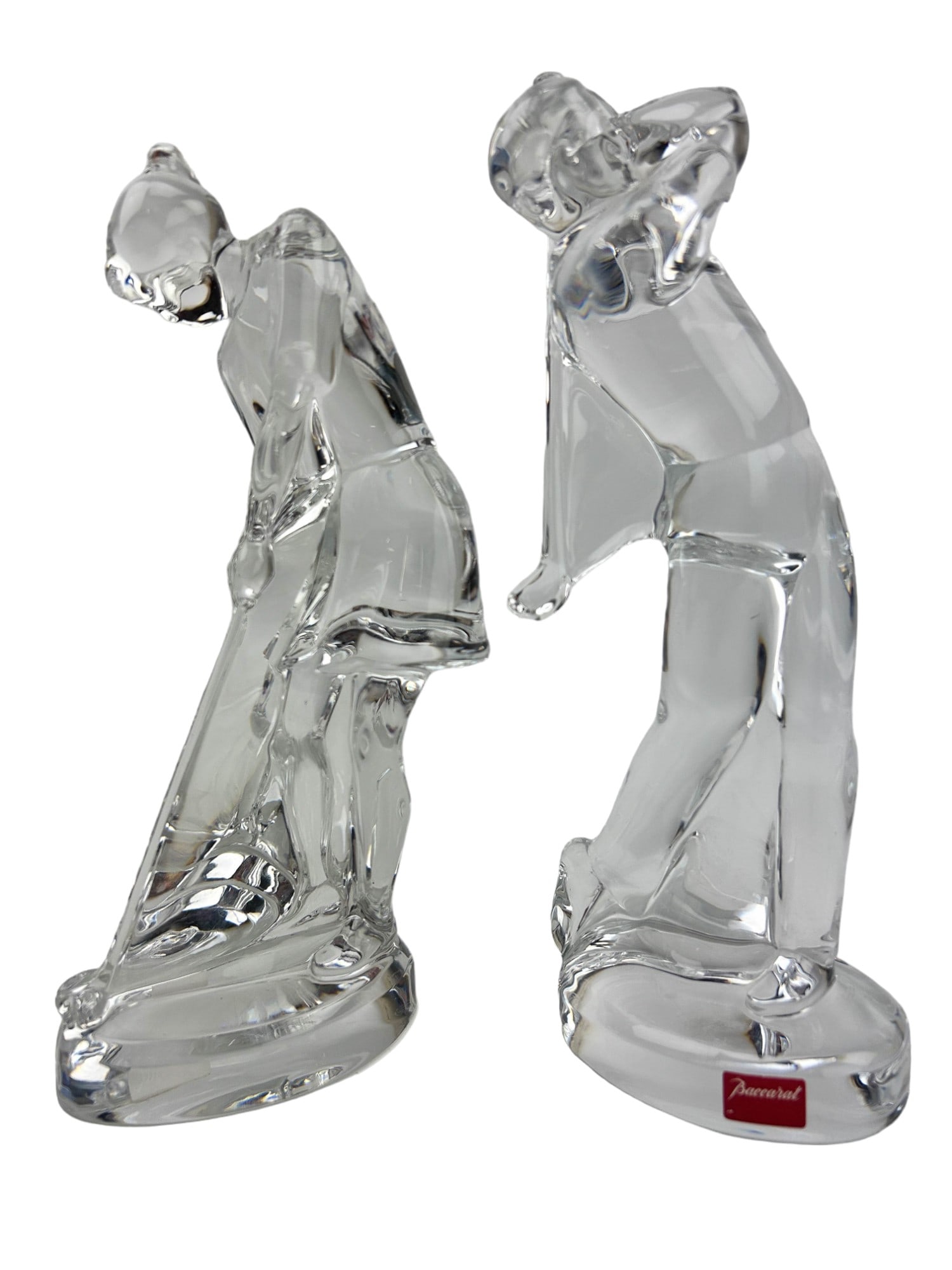 Baccarat Crystal Male & Female Golfer Sculptures: Manufacture : Baccarat. Country of origin : France. Circa : 20th Century. Estate lot of two (2) clear art glass curio cabinet display figurines. Both with a Golf / Golfing sports themed influence. One