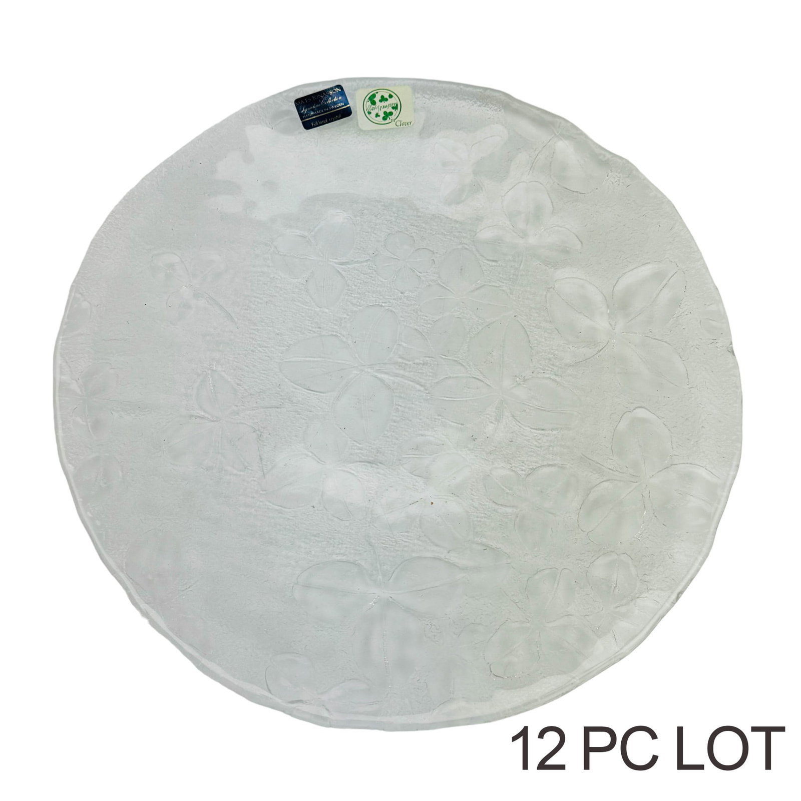 Mats Jonasson Swedish Crystal Clover Plates 12pc: Sweden Late 20th Century Lead Crystal Art Glass Plates. Designer : Mats Jonasson for Maleras Glasbruk. Each graced with a clear three clover leaf and stem pattern on the underside against a frosted pe
