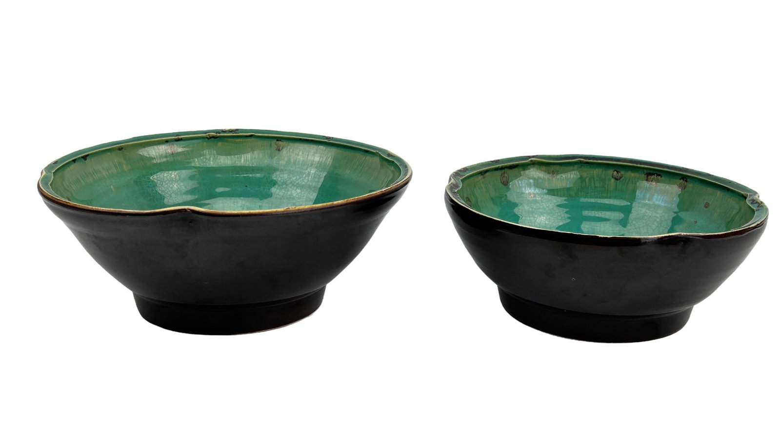Asian Green Brown Glaze Porcelain Ceramic Bowls: Estate lot of a total of two (2) round bowls each with a scalloped like border. Interiors with a green coloration with brown spotted areas and a cream yellow patch. Outside with a rich dark brown colo