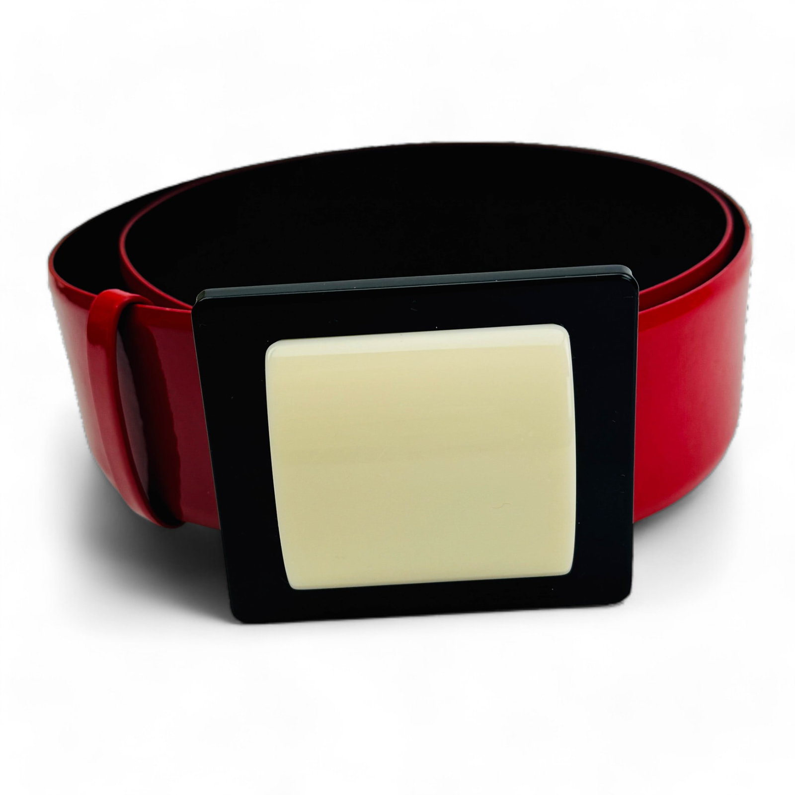 Chanel Red Patent Leather Black White Lady's Belt: French luxury designer women's accessory. Features a deep red colored wide body and finished with a rectangular black belt buckle accented with and off white cream colored rectangular convex accent. B