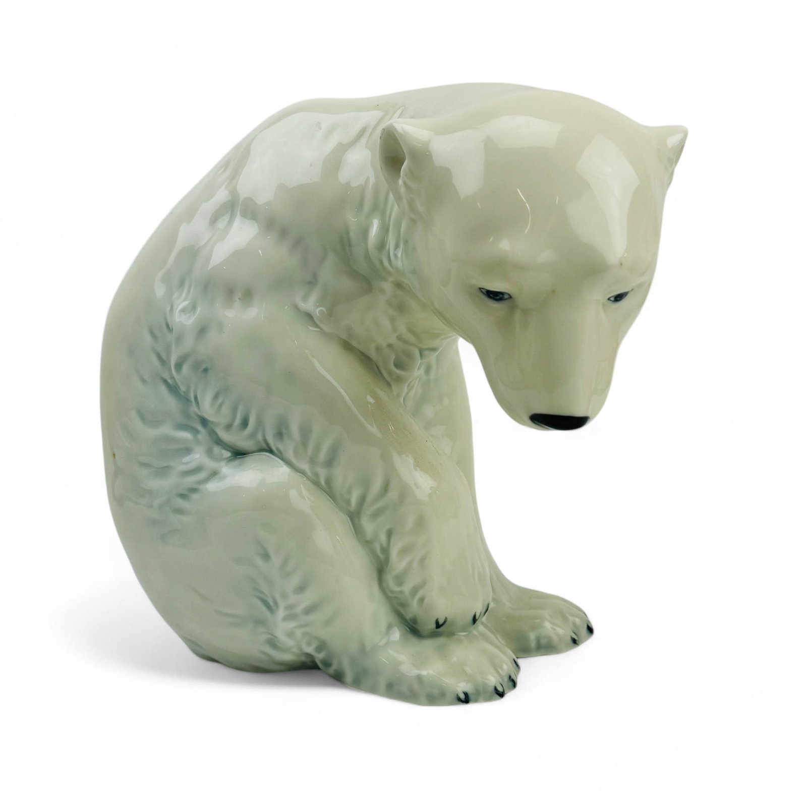 Porsgrund Norwegian Porcelain Polar Bear Sculpture: Manufacturer : Porsgrund. Country of origin : Norway. Designer : Johan Sirnes (Norwegian, 1883 - 1966 ). Features this Arctic native carnivorous mammal in seated / resting pose. Well detailed in manne