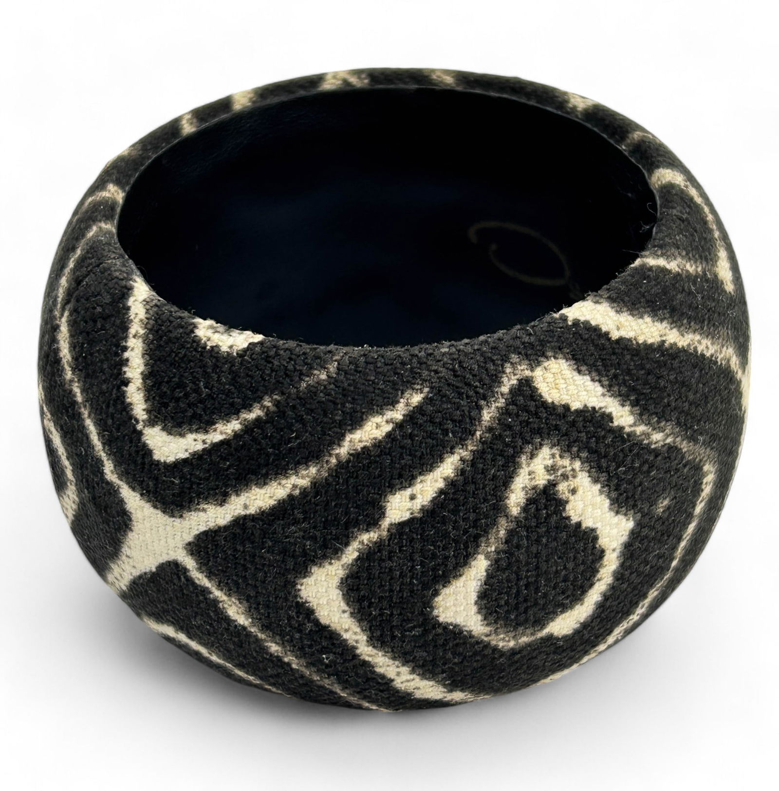 Oscar de la Renta Fabric Covered Bangle Bracelet: A stylish wide bangle bracelet by Oscar de la Renta. Features a bold, tribal primitive pattern in white and black fabric, wrapped around a sturdy inner structure which is lined with leather. Measures