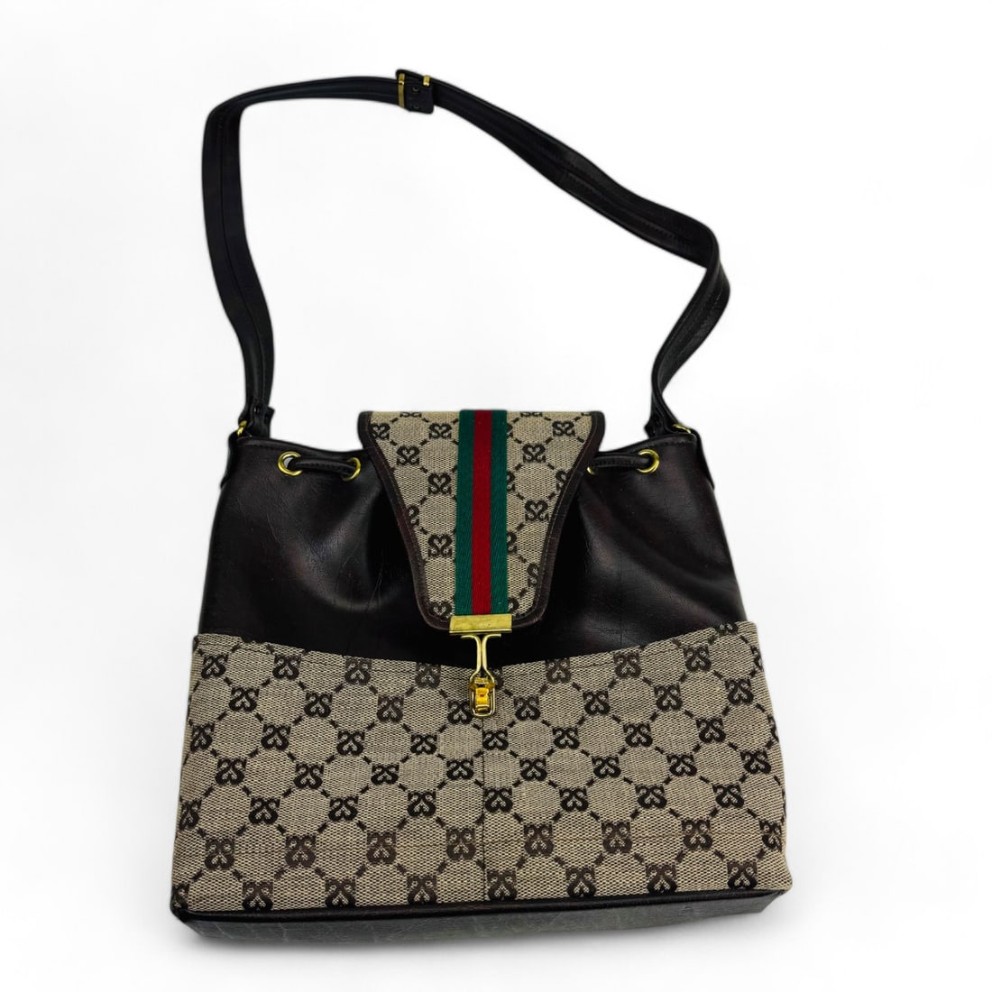 Sans Souci Originals by Jacques Leather Canvas Bag: Vintage Sans Souci Originals by Jacques shoulder bag features a distinct combination of brown leather and monogrammed canvas. The bag's structured body is adorned with the classic Sans Souci "SS" moti