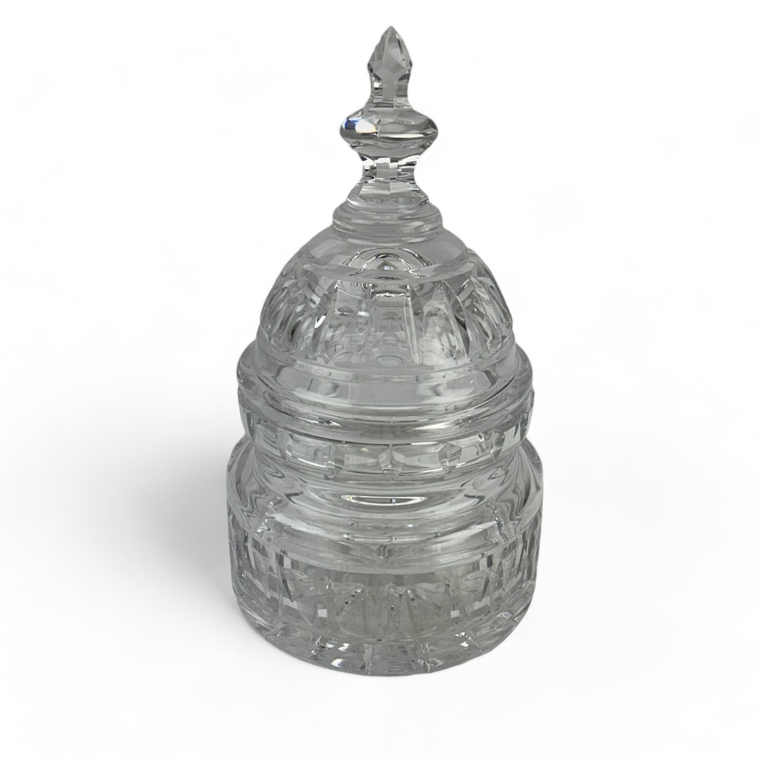 Waterford Crystal Capital Dome Biscuit Barrel: A finely crafted Waterford Crystal biscuit barrel featuring a dome -shaped lid with a cut finial. Signed with Waterford Mark on base. Dimensions: 9.75 X 5.5 X 5.5 in. Condition: Good Overall Condi