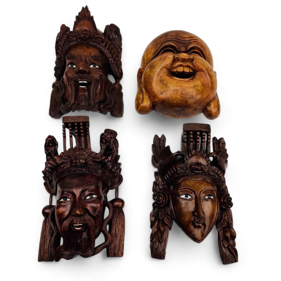 Chinese Wooden Masks of Buddha, Emperor & Empress: An estate collection lot of four hand carved Chinese export wooden masks, featuring representations of Buddha, an emperor, and an empress. Each with detailed facial features and symbolic headpieces, c