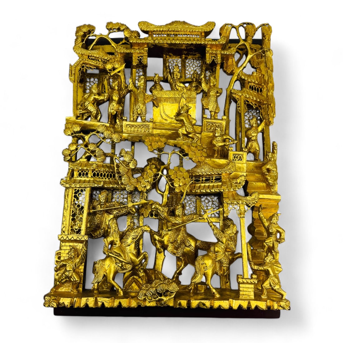 Chinese Gilt Wooden Plaque w/ Warriors in Combat: A well carved Chinese gilt wood plaque showcasing a dynamic scene of warriors in combat, mounted on horseback and brandishing weapons. The intricate craftsmanship is evident in the elaborate pierced b