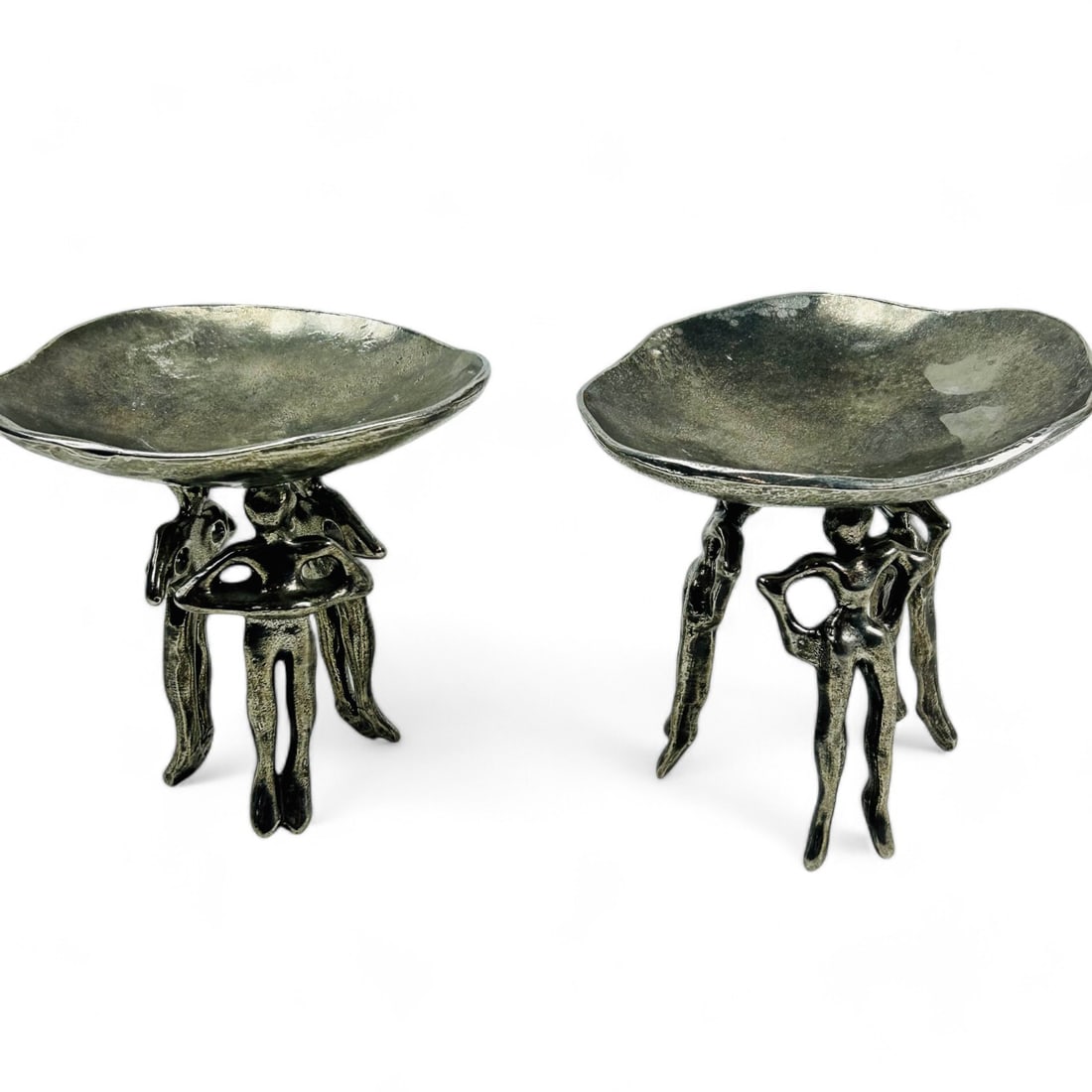 Brutalist Carrol Boyes Style Figural Metal Tazzas: A pair of striking Brutalist style metal tazza compote dishes featuring figural supports reminiscent of Carrol Boyes (celebrated and acclaimed South African artist and designer ).aesthetic. These piec