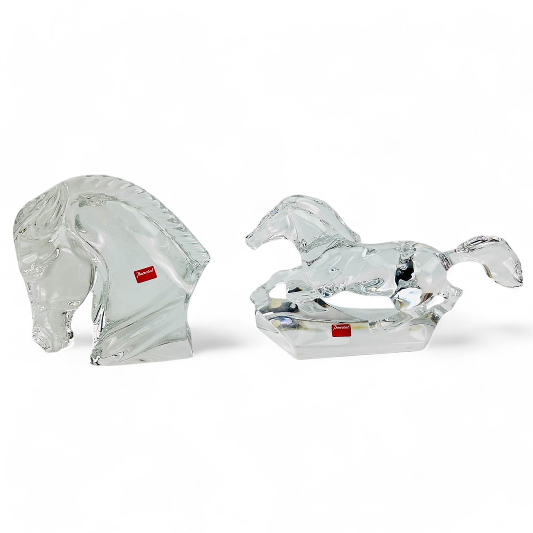 Baccarat Trotting Horse Bust Head Glass Sculptures: Lot of two (2) Baccarat France equestrian theme clear crystal art glass sculptures comprising of a trotting horse and a bust head. The trotting horse sculpture showcases dynamic motion, the bust head 