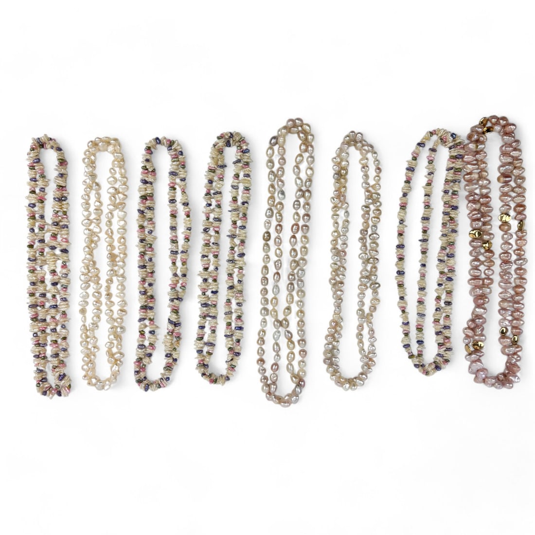 Estate Lot Freshwater Pearl Necklaces 8pc LOT: A diverse collection of eight freshwater pearl necklaces showcasing a variety of styles and colors. This estate lot features strands of pearls with natural irregular shapes, creamy white tones, soft p