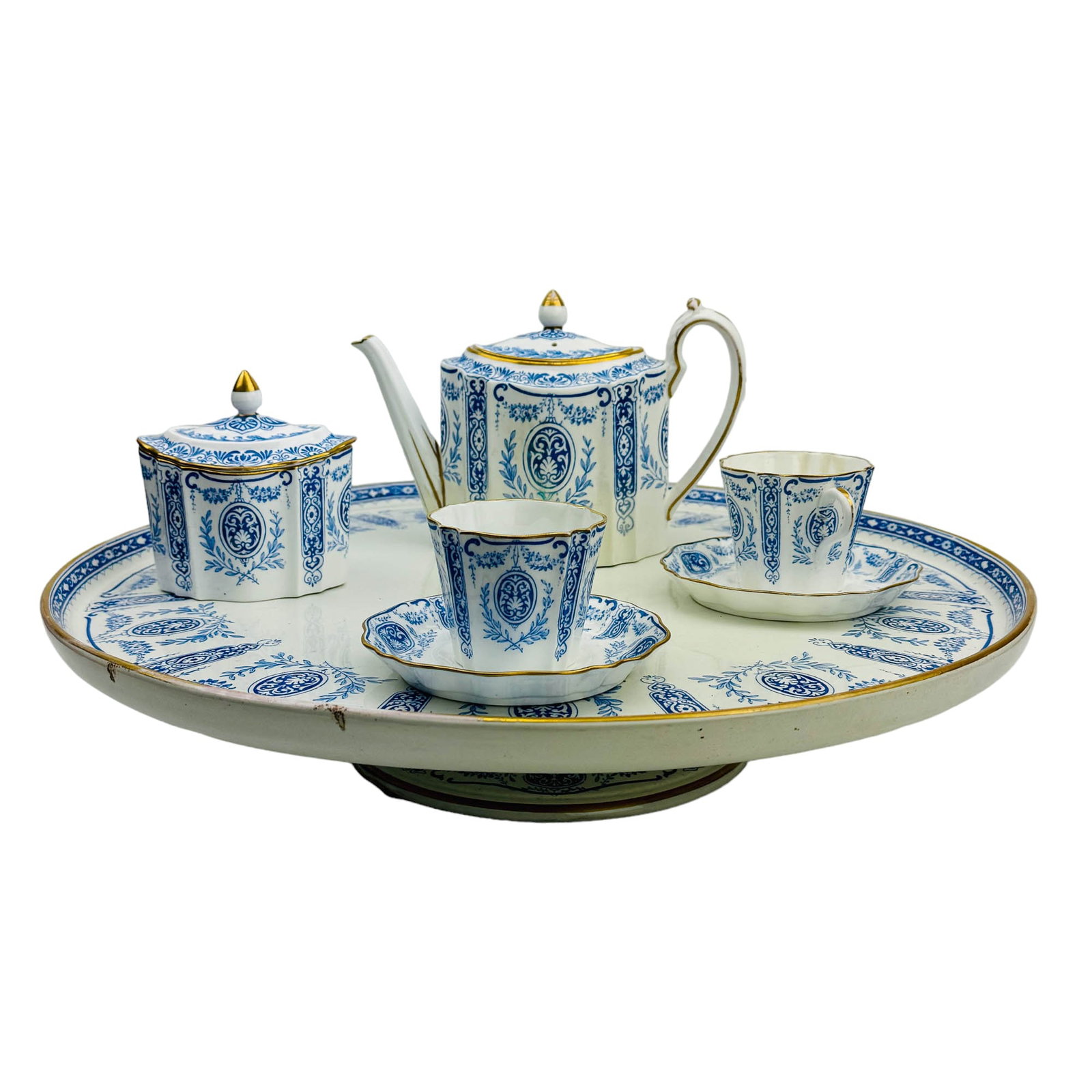 Wedgwood Blue Floral Bone China Tea Set & Tray: Wedgwood 20th century English bone china tea coffee pot, two (2) cups, two (2) saucers, a covered sugar bowl and a large round footed pedestal tray. Articles decorated with a blue floral, scroll and a