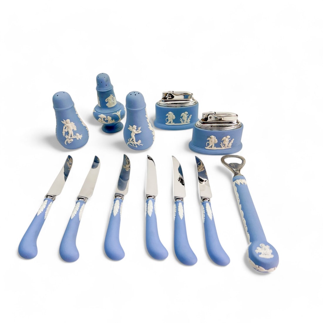 Wedgwood Blue Jasperware Knife Set Lighter Shakers: Estate collection lot that includes a boxed set of six knives, two (2) table cigarette lighters, a bottle opener and three (3) salt and pepper shakers. All feature a Neoclassical scenes and motifs of