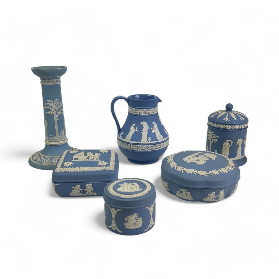 Wedgwood Blue Jasperware Box Candle Holder Jug 6pc: Estate collection lot of a total of six (6) Wedgwood England blue jasperware decorative / utilitarian objects. All feature a Neoclassical mythological scene or motif featuring winded nude heavenly che