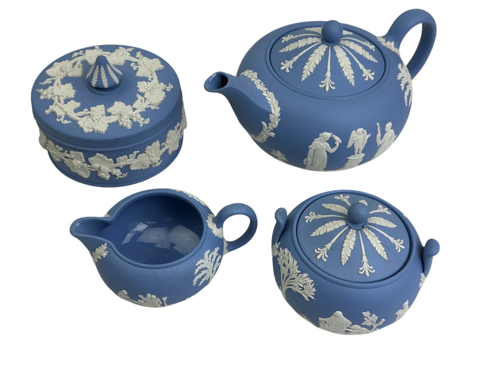 Wedgwood Blue Jasperware Teapot Creamer Sugar Box: Wedgwood England 20th century blue jasperware four piece set, including a lidded teapot, creamer, lidded sugar bowl and covered jewelry, trinket, ring, coin storage box. All feature the iconic matte b