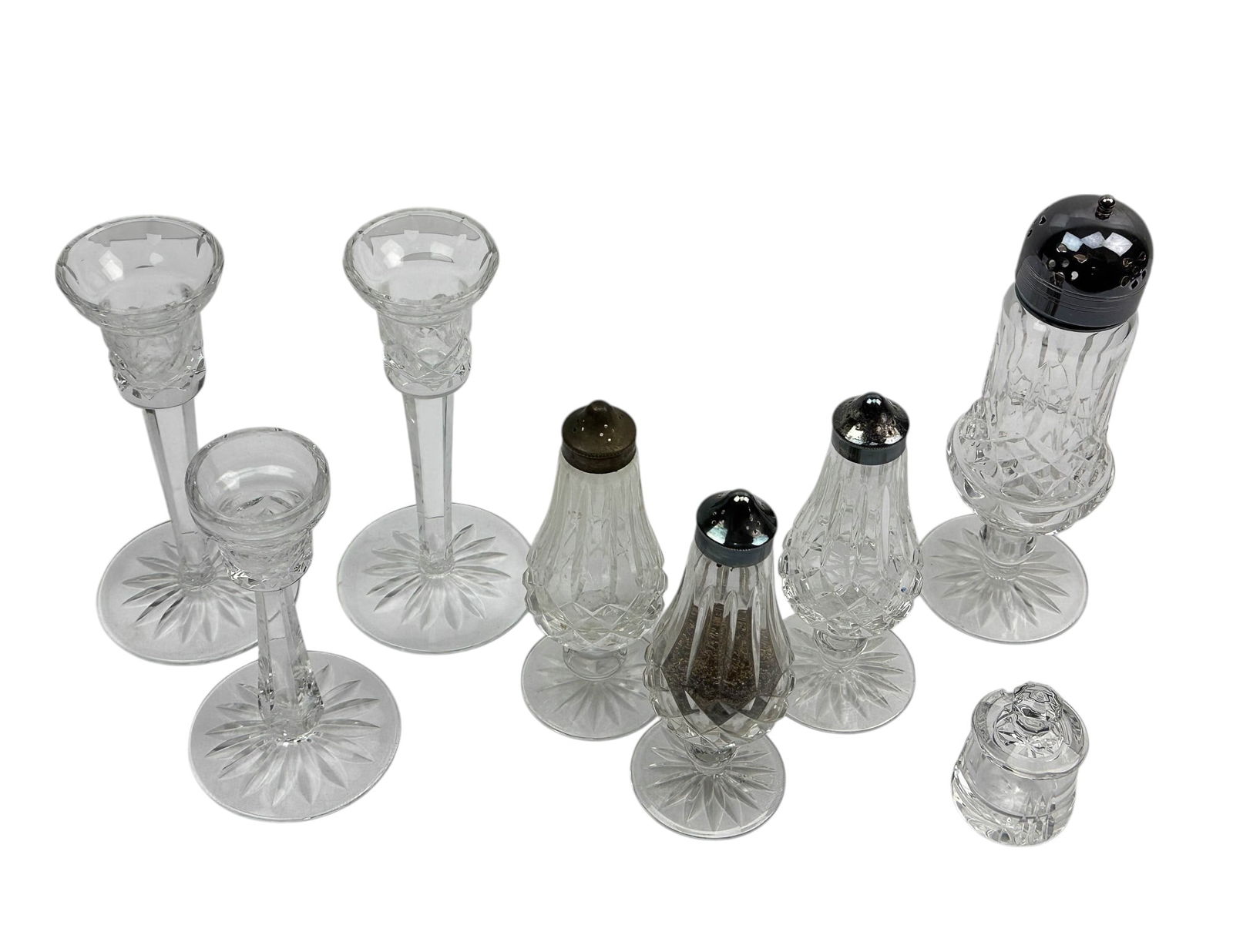 Waterford S&P Shakers, Muffineer & Candleholders: An estate collection lot of a total (8) eight Waterford Irish cut crystal art glass dinner ware kitchenware and decorative objects. Includes ~ Three (3) Salt / Pepper shakers with silver plated cap to