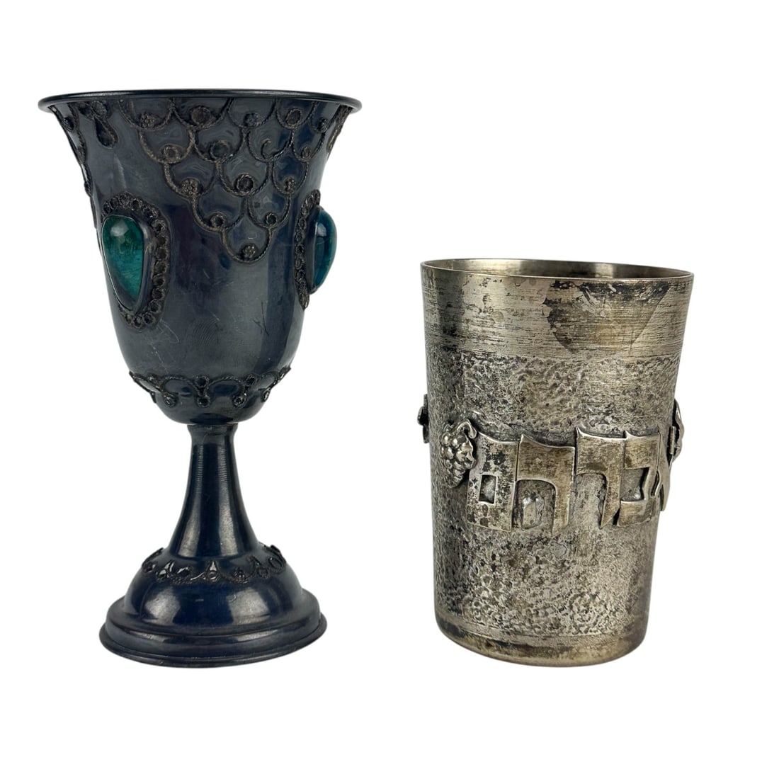Sterling Silver Jewish Judaica Wine Kiddush Cup 2p: Lot of two (2) sterling silver 925 Jewish Judaica ceremonial vodka drinking cups. One is a traditional cylindrical Kiddush cup adorned with applied Hebrew text and decorative motifs. The second is a g
