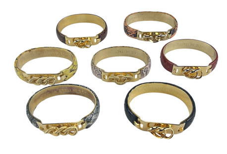 Italy Made 7 pc Lot 24k Gold Plated Bracelets: Italian made lot of seven (7) designer 24k gold plated bracelets. Each of the bracelets accented in snakeskin with rope decorated closures. The bracelets are all signed inside. Two (2) are signed Picc