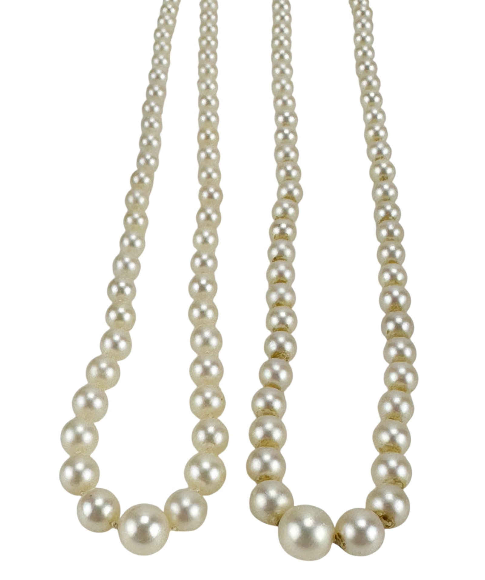 Saltwater Cultured Akoya Pearl Diamond Necklace 2p: Lot of two graduated saltwater cultured Akoya pearl necklaces with platinum clasps. One necklace features a clasp with a pierced filigree setting containing a diamond accents. The other is also gradua