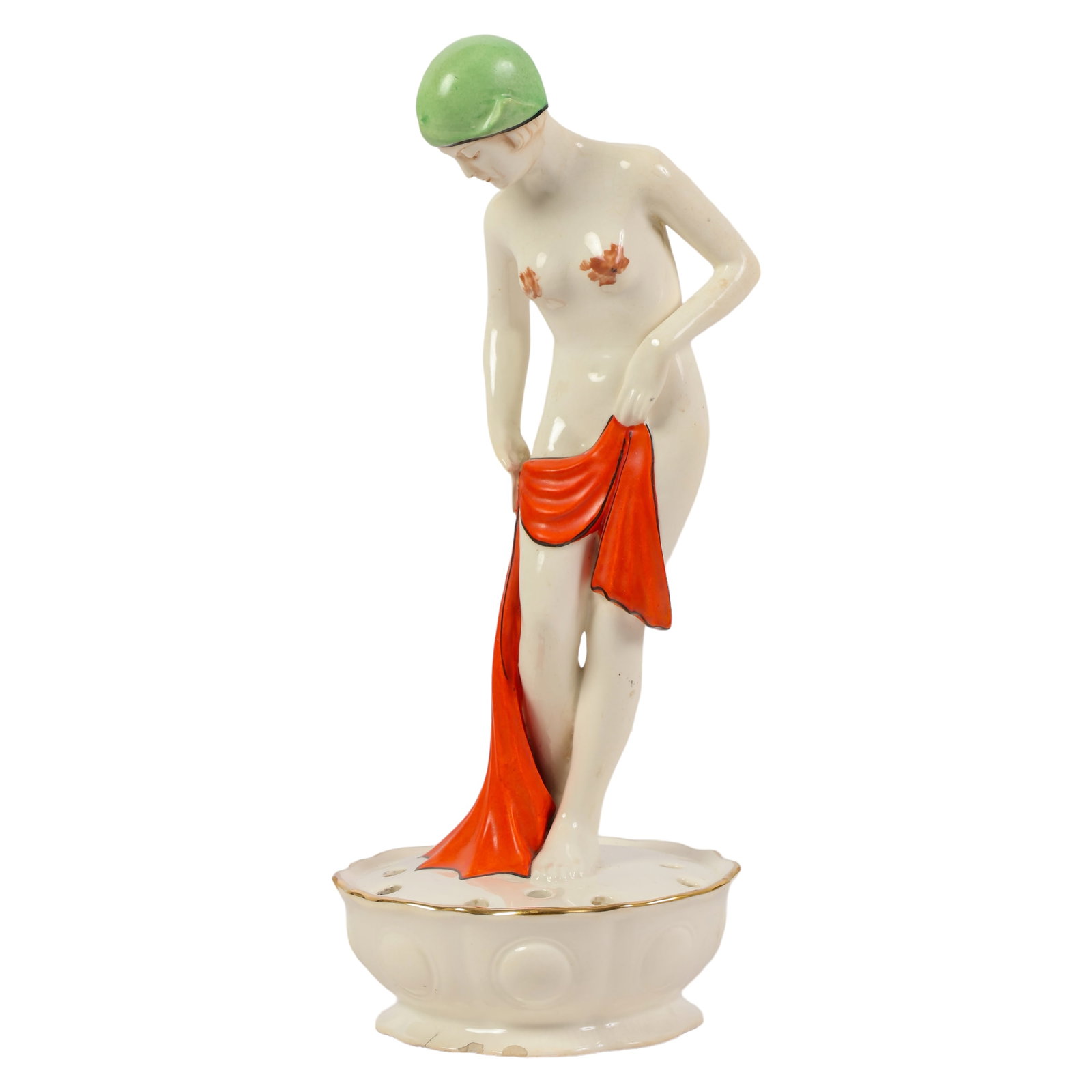 Art Deco Semi-Nude Figural Porcelain Flower Frog: An antique Czechoslovakian porcelain figural flower frog centerpiece. It features an Art Deco glazed white nude bathing beauty with a green bathing cap and red towel, standing on a round form pierced 