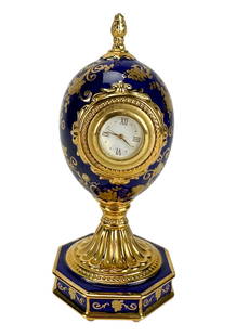 House of Faberge Rose Bouquet Porcelain Clock Egg: House of Faberge limited edition Rose Bouquet clock miniature egg. The egg form case is decorated in cobalt blue with gold gilt floral designs and mounted on a fluted pedestal over an octagonal base.