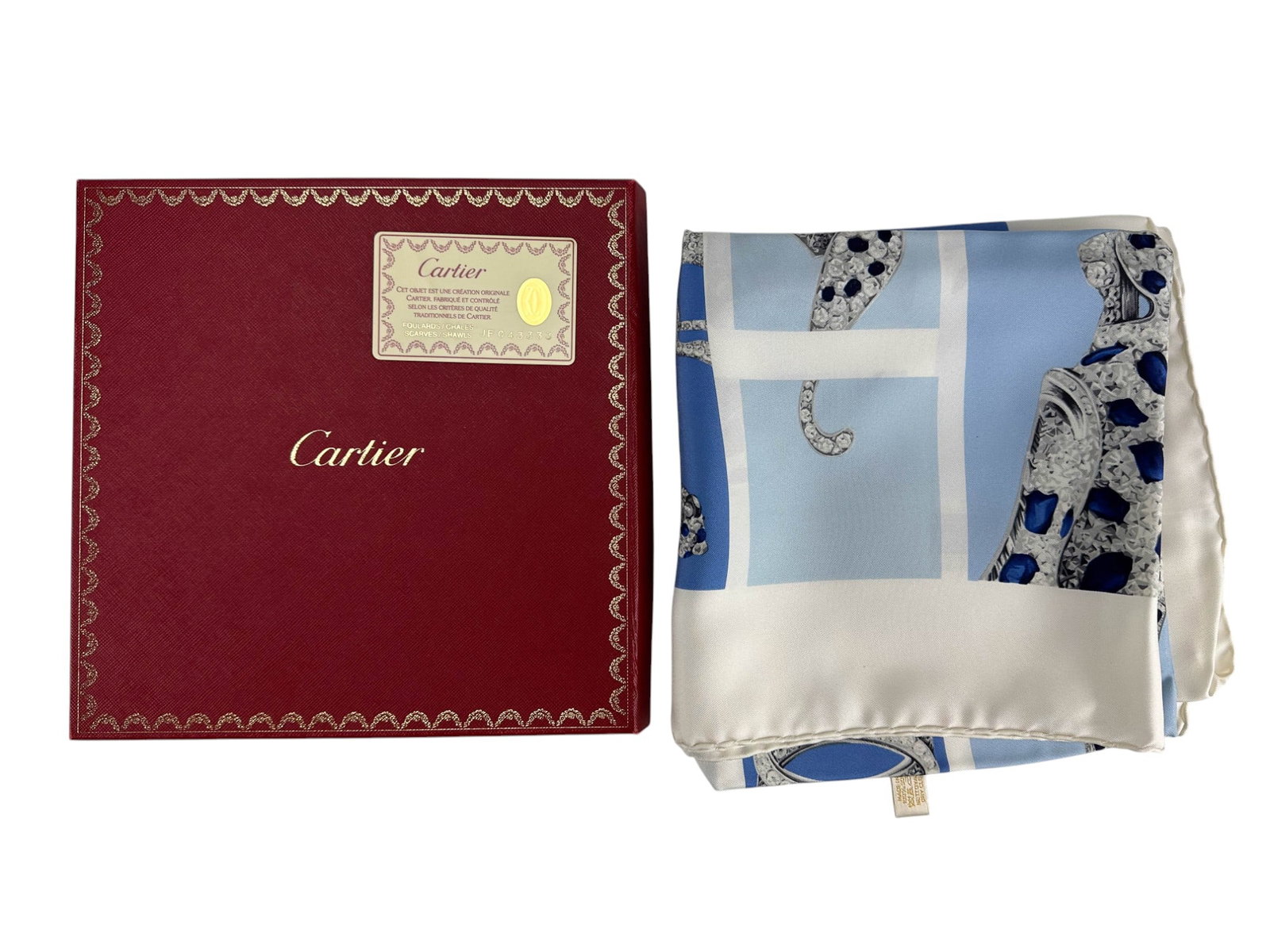 Cartier Paris Panthere Designer Silk Scarf w/ Box: Cartier Paris France luxury silk scarf depicting multiple views of the iconic Panthere design composed of simulated diamond and sapphire forms. The scarf features graphic panels with iterations of Car