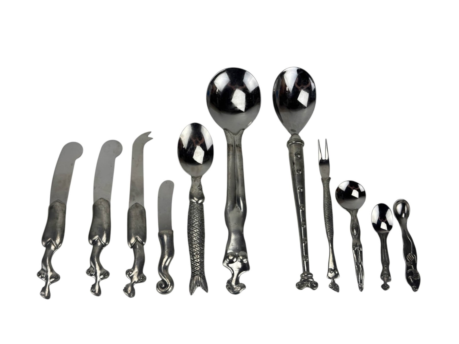Carrol Boyes Aluminum Stainless Flatware 11pc LOT: Carrol Boyes grouping of eleven sculptural aluminum and or stainless steel cutlery utensils serve ware pieces. This eclectic collection includes various spoons, knives, forks, and spreaders, each with