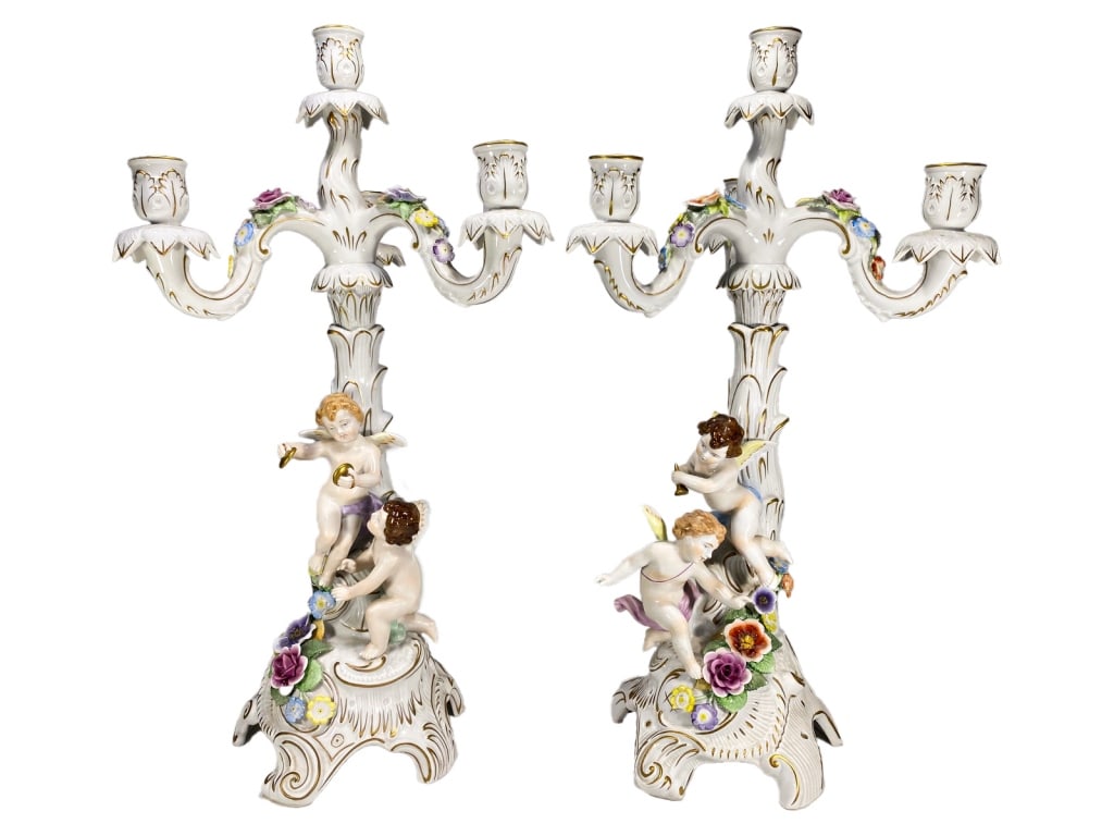Schierholz German Porcelain Candelabras 2pc LOT: Schierholz (Germany), pair of hand-painted porcelain three-light candelabras featuring rococo-style scrolled footed bases and columns supporting three gilt-accented candle arms. Each base is adorned w