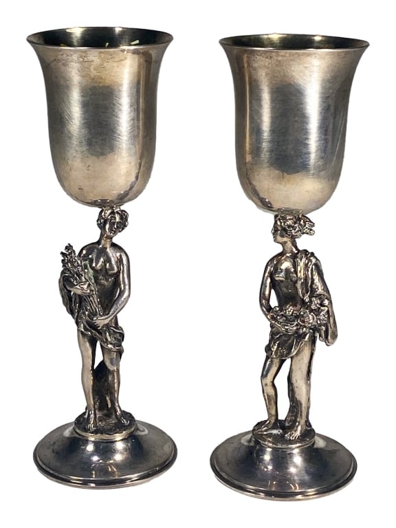 Asprey of London Pair Neoclassical Silver Goblets 2 pc LOT: A finely crafted pair of sterling silver figural sherry wine goblets by Asprey & Co. of London, each featuring a detailed sculpture of a classical figure as the stem. The goblets are elegantly proport