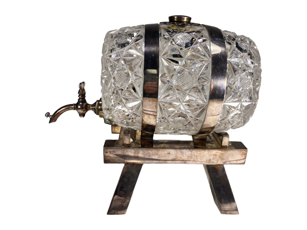 Asprey of London Crystal & Silverplate Wine Barrel: A finely crafted figural decanter by Asprey & Co. of London, designed in the shape of a barrel. The body of the decanter is made from intricately cut crystal, showcasing Asprey's attention to detail.