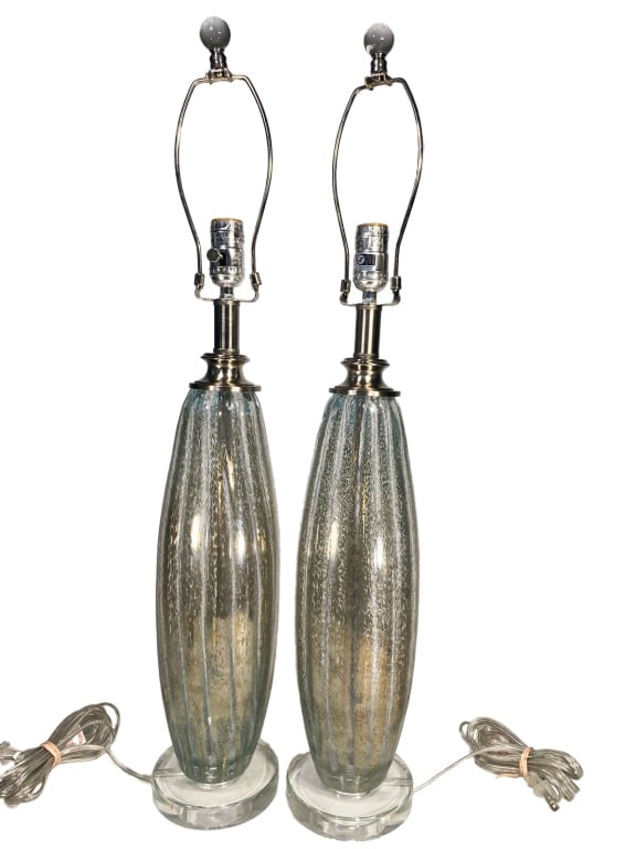Murano Glass & Silver Pair of Aqua Table Lamps: Pair of Murano glass table lamps with ribbed bodies in silver and pale aqua tones, resting on clear glass bases. Crafted in nickel hardware with harp fittings included. Each lamp measures approximatel