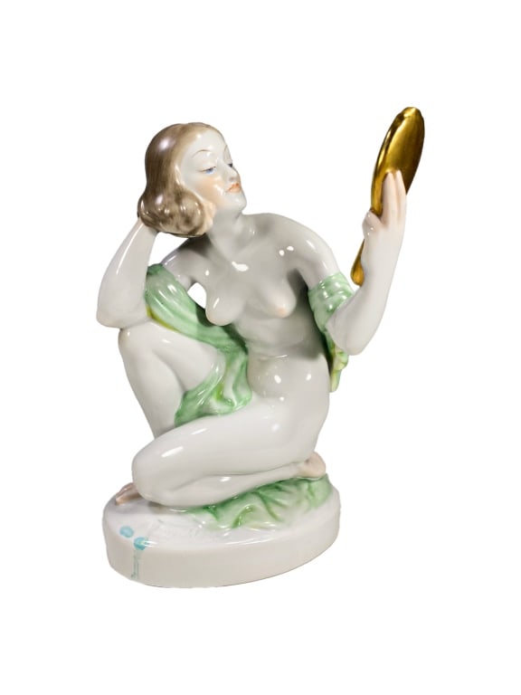 Herend Hungarian Nude w/ Mirror Porcelain Figurine: A Herend, finely detailed hand painted porcelain figurine of a nude woman in a kneeling pose, gazing into a gold-painted hand mirror. She is partially draped with a soft green wrap across her shoulder