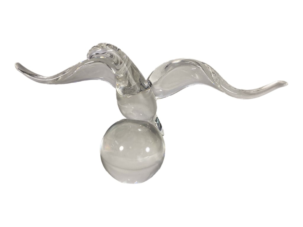 Steuben Clear Crystal Seagull on Orb Sculpture: A Steuben crystal sculpture of a seagull with outstretched wings, perched atop a smooth orb base. The dynamic form features subtle curvature and balance. Script-etched 'Steuben' signature to its under