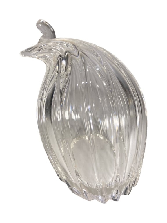 Steuben Clear Crystal Art Glass Quail Sculpture: Steuben, an American clear crystal quail figurine with a ribbed swirling body, scalloped base, small crest, and pointed beak. Retains the etched 'Steuben' signature to its underside.Dimensions: 5.5 X