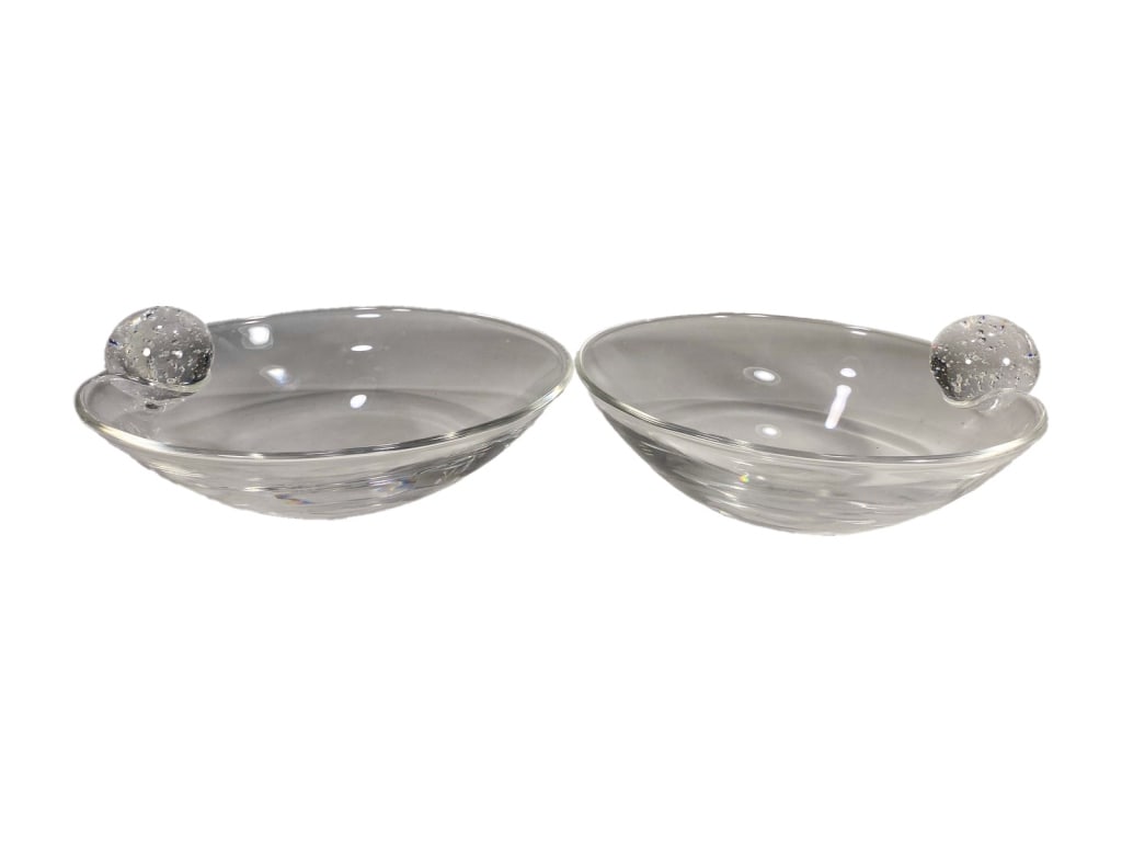 Steuben Pr of Clear Crystal Oval Bubble Orb Bowls: A Steuben pair of clear crystal shallow oval bowls, each featuring a smooth rim and a single applied spherical element with controlled air bubbles throughout. Each bear a Steuben signature to their ba