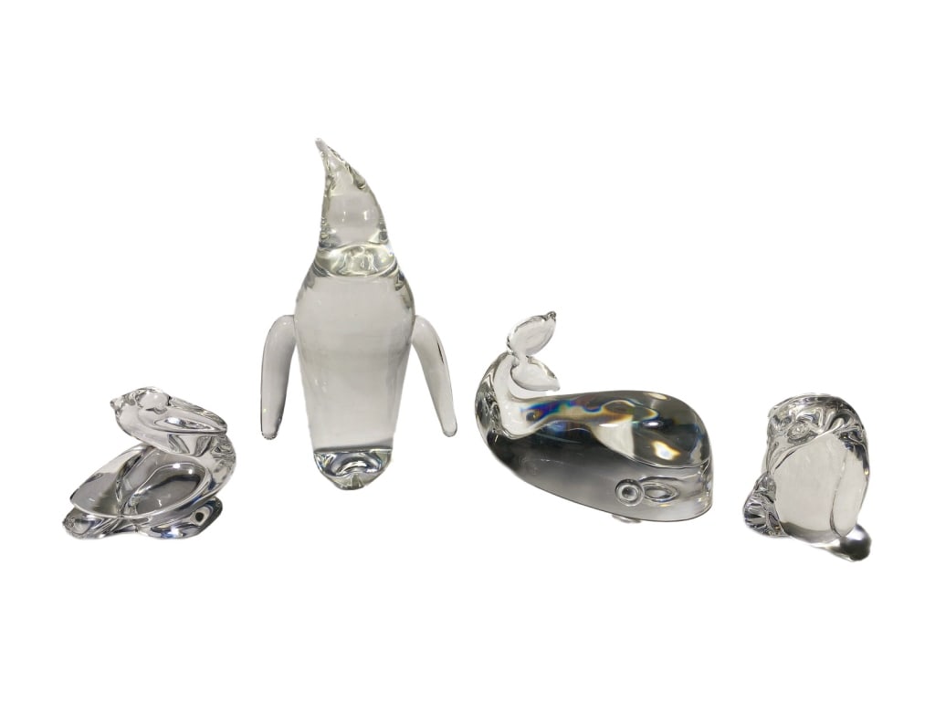 Steuben Crystal Art Glass Animal Figurines 4pc LOT: Steuben, four clear crystal animal figurines including one penguin with a tall curved beak, one whale with an upward tail, one pelican, and one penguin feeding a chick. Each signed Steuben in script.