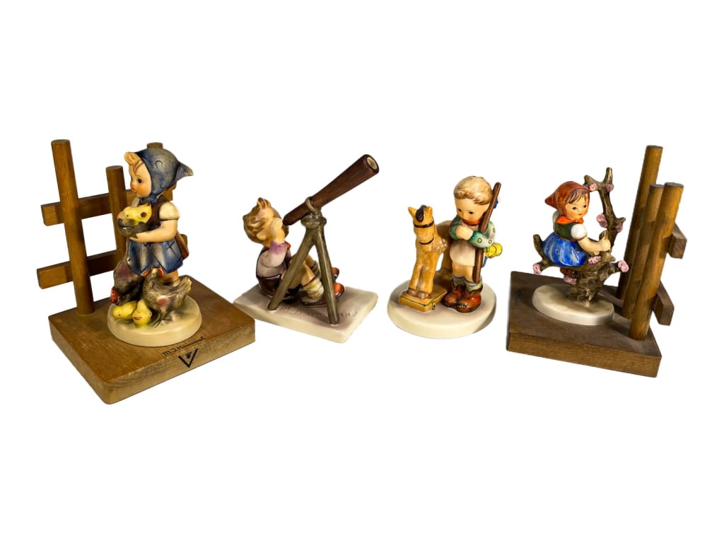 Hummel Goebel German Porcelain Figurines 4pc LOT: Lot of four Hummel figurines, each modeled with expressive child figures. All bear Goebel or M.I. Hummel marks. The largest measures approximately 5 inches tall by 3.75 inches wide by 3.65 inches deep