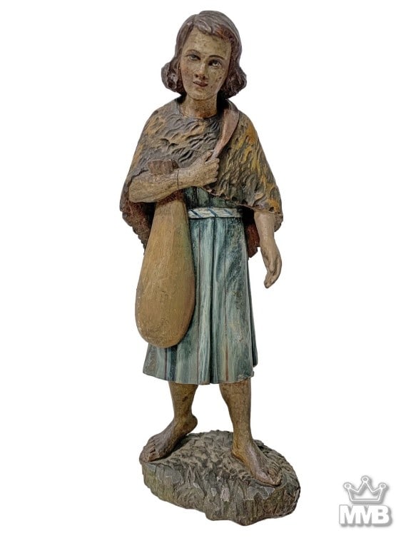 Antique Religious Hand Carved Wooden Sculpture: Turn of the century, hand carved wood sculpture of a male religious figure of youth, shown barefoot with shoulder-length hair, a fur-textured cape, blue-green robe and a bag slung across the chest, st