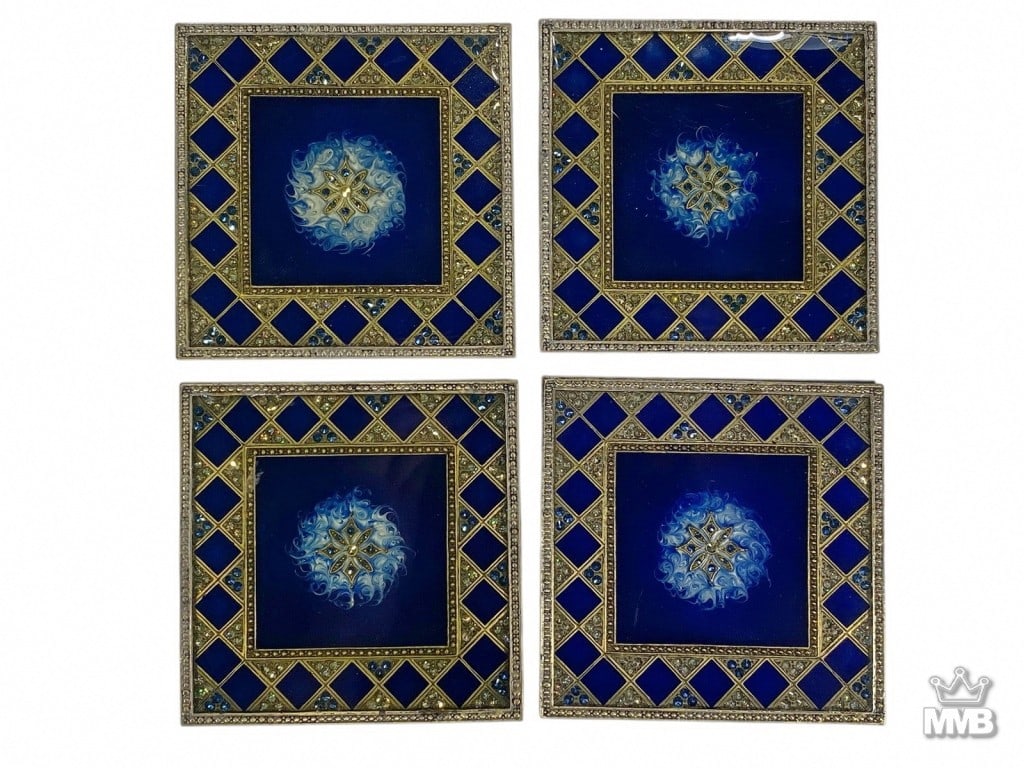 Tizo Jeweled Square Enameled Coasters 4pc LOT: Set of four square coasters with cobalt blue enamel centers featuring jeweled floral medallions, surrounded by gilt lattice borders accented with blue and clear stones. Each coaster measures approxima