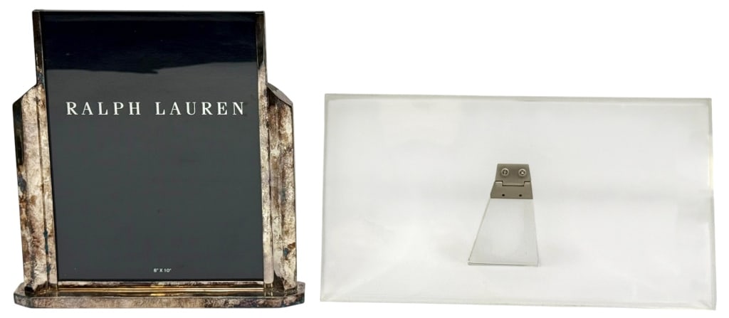 Silvered Ralph Lauren & Calvin Klein Lucite Frames: Lot of two vintage designer picture frames. To include a Ralph Lauren silver-plated deco style frame and a Calvin Klein acrylic Lucite frame. Ralph Lauren: stamped 'RALPH LAUREN' on the underside. Cal